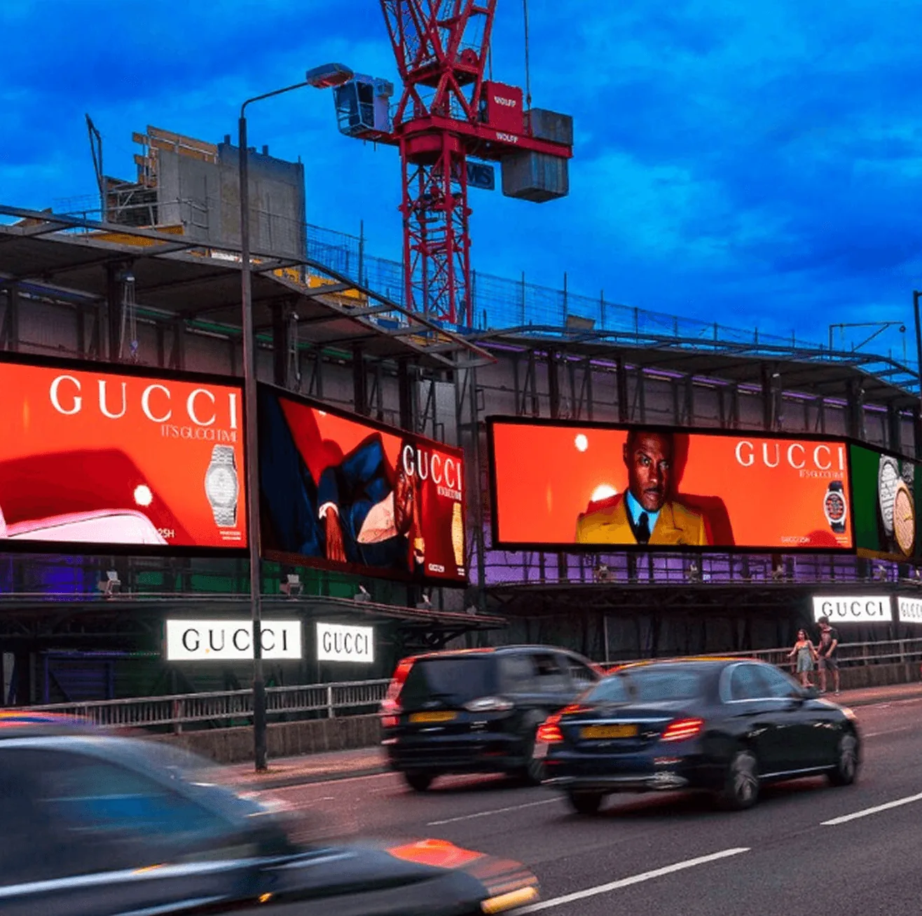 Large digital billboards displaying advertising above busy city street at dusk