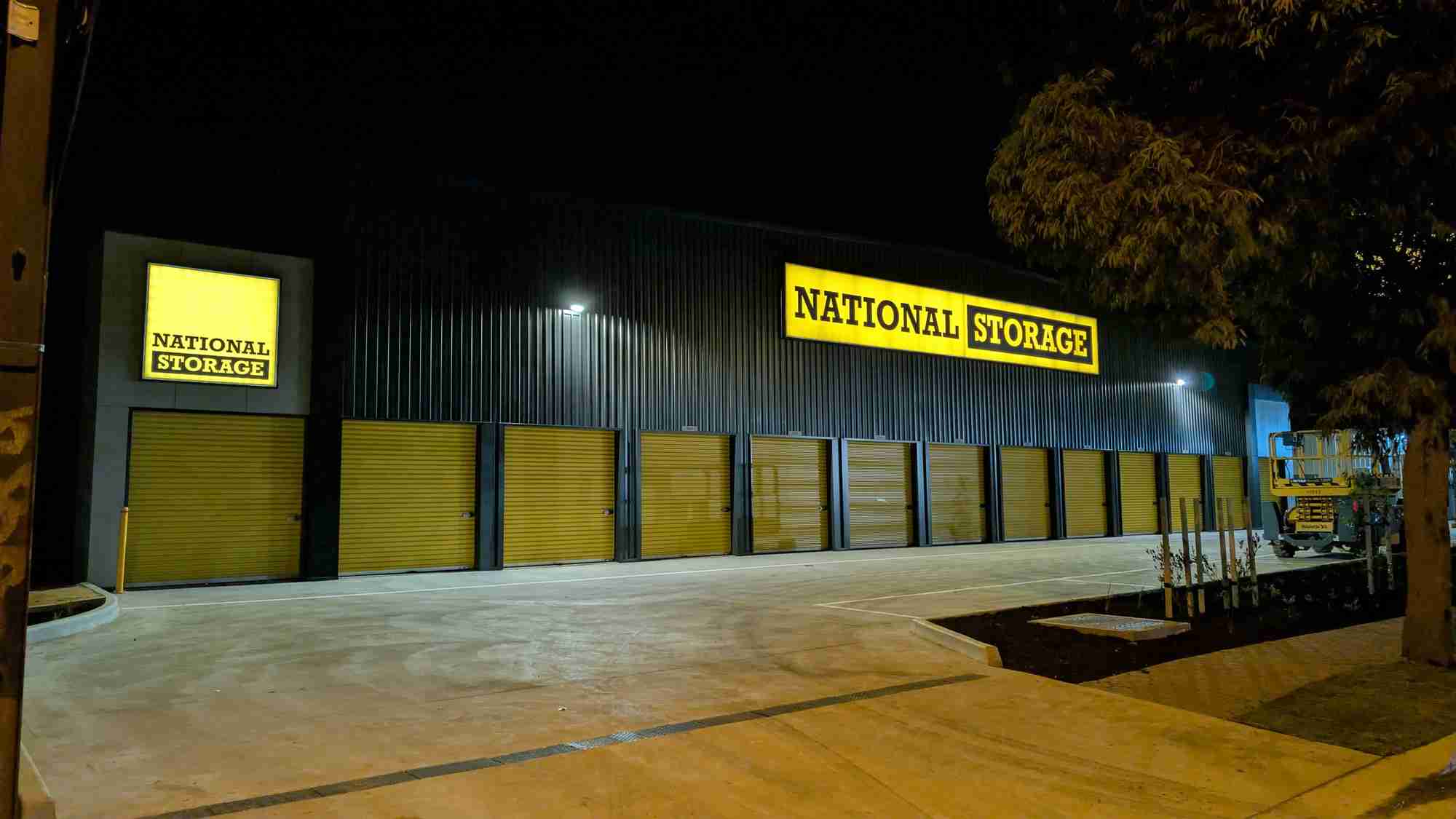 Illuminated lightbox sign glowing at night in Adelaide