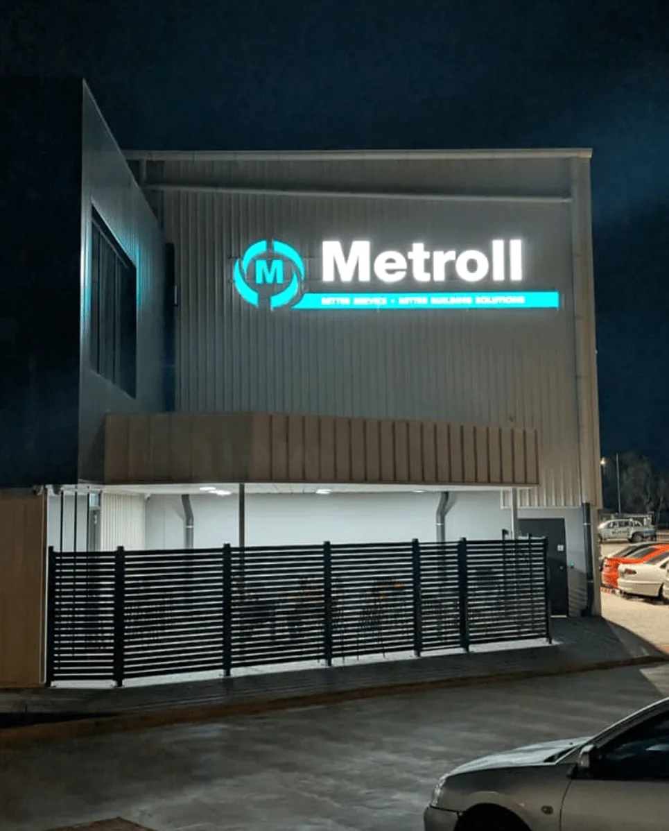 Metroll illuminated signage installed on modern commercial building facade